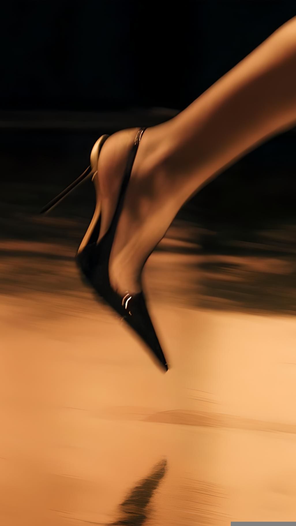 A woman's heel captured mid-stride in warm motion blur